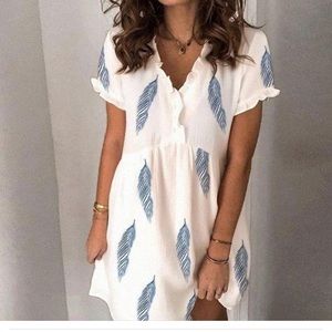 Short loose fitting whimsical feather print dress.